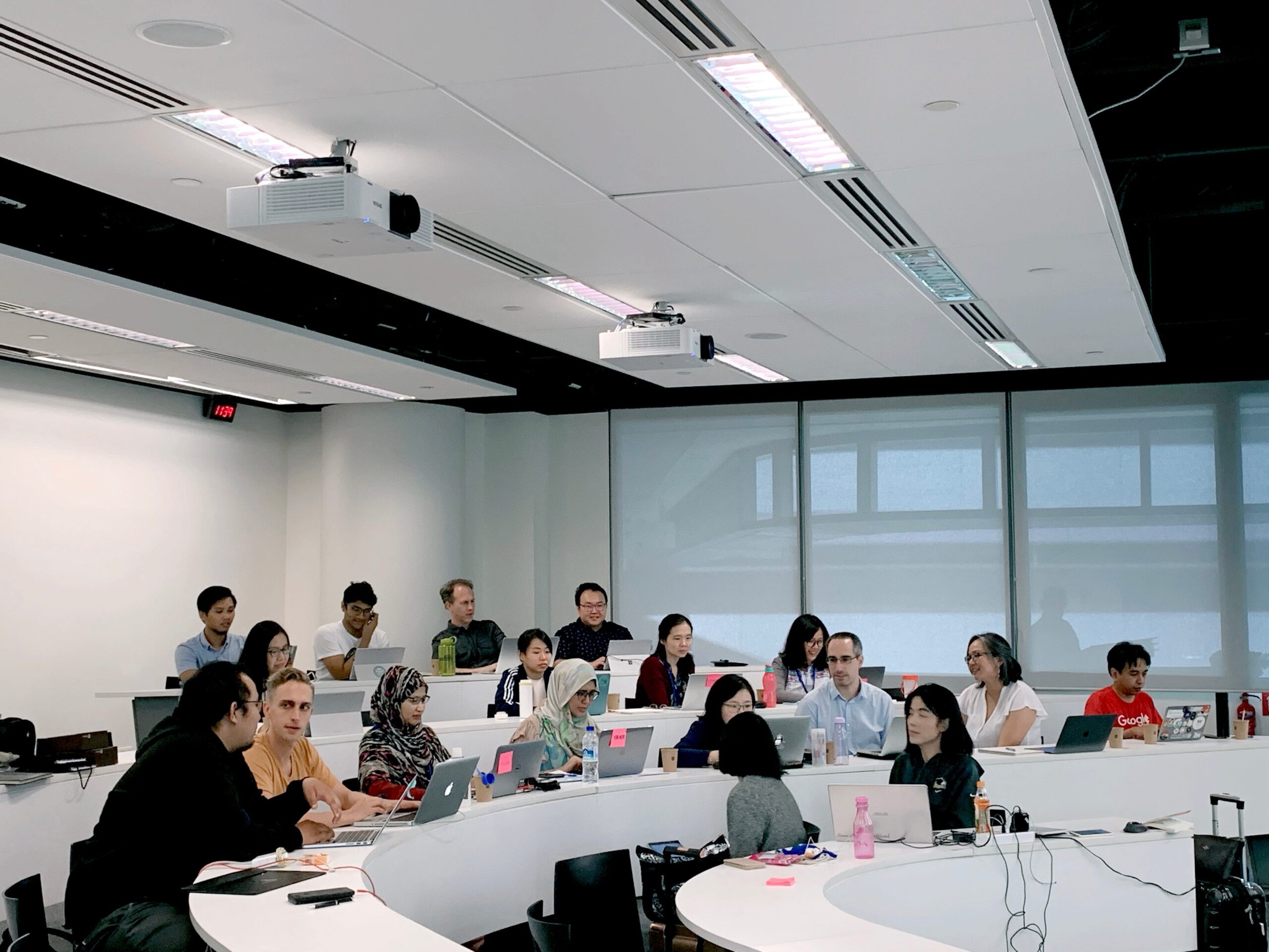 A group of diverse students studying together in a modern university library, highlighting the collaborative learning environment.