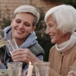 Smiling caregiver assisting senior woman