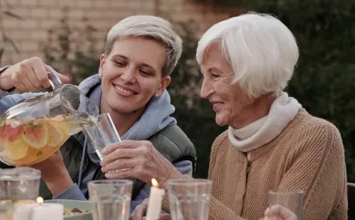 Smiling caregiver assisting senior woman