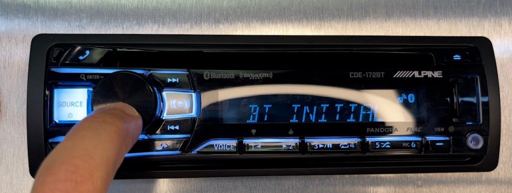 Close-up of Alpine car stereo display showing Bluetooth pairing menu, demonstrating how to clear Bluetooth memory for troubleshooting connectivity issues.