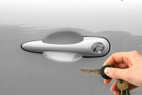 Man using a basic car key to open a car door