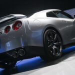 Silver Nissan sports car showcased at an auto event