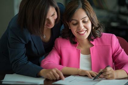 Professional women collaborating on a career development plan within the refugee career pathways program.