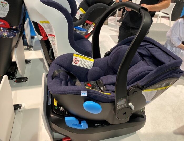 Infant car seat for free program eligibility and safety. Securely installed infant car seat in its base, demonstrating proper child passenger safety equipment.