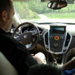 Jarrod Snider in the autonomous-driving lab, emphasizing computer control over vehicle functions