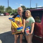 Family receiving pet food assistance from DaisyCares Pet Food Program for their dog.