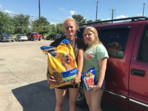 Family receiving pet food assistance from DaisyCares Pet Food Program for their dog.