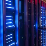 man standing in server room looking at server rack