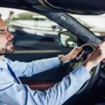 Man programming car mirror buttons to open garage door, emphasizing ease of access for industrial and residential settings.