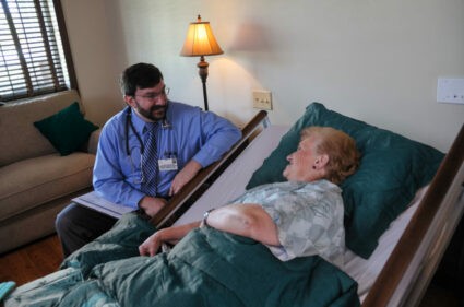 Doctor discussing care options with patient, highlighting the differences between hospice and palliative care.