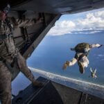 Paratrooper representing military personnel eligible for national benefits programs, including car purchase discounts.