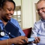 Practical nurse preparing medication for a patient