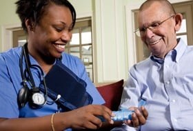 Practical nurse preparing medication for a patient