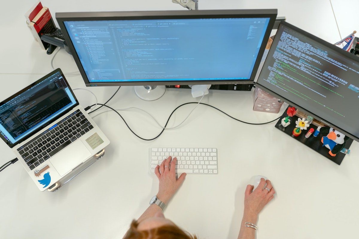 Cloud solutions architect designing cloud infrastructure on a computer.