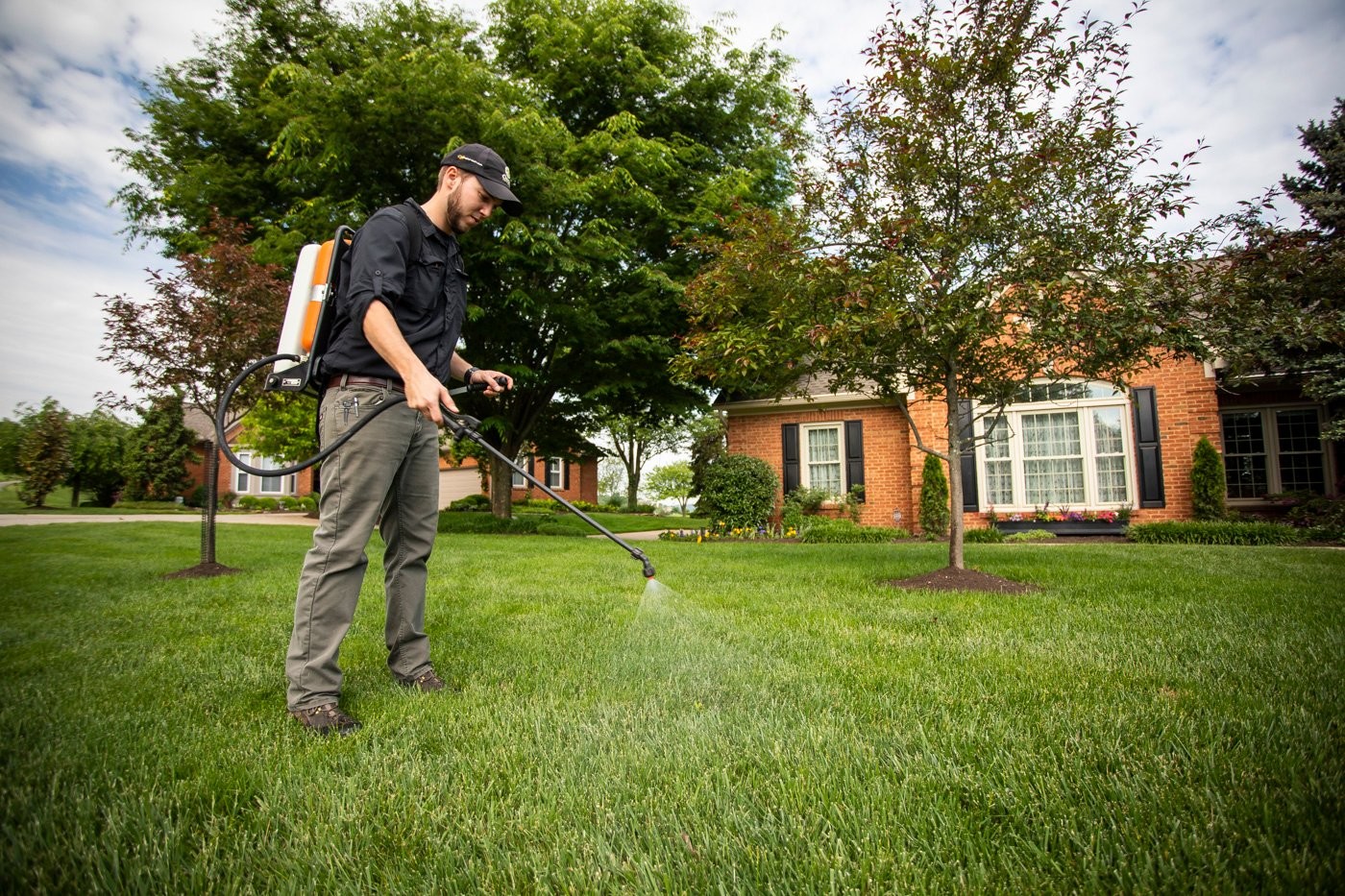 Lawn technician applying crabgrass pre-emergent