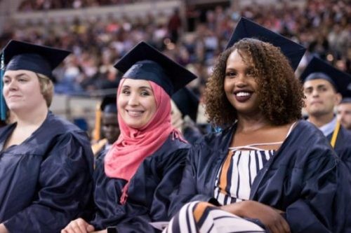 three smiling grads